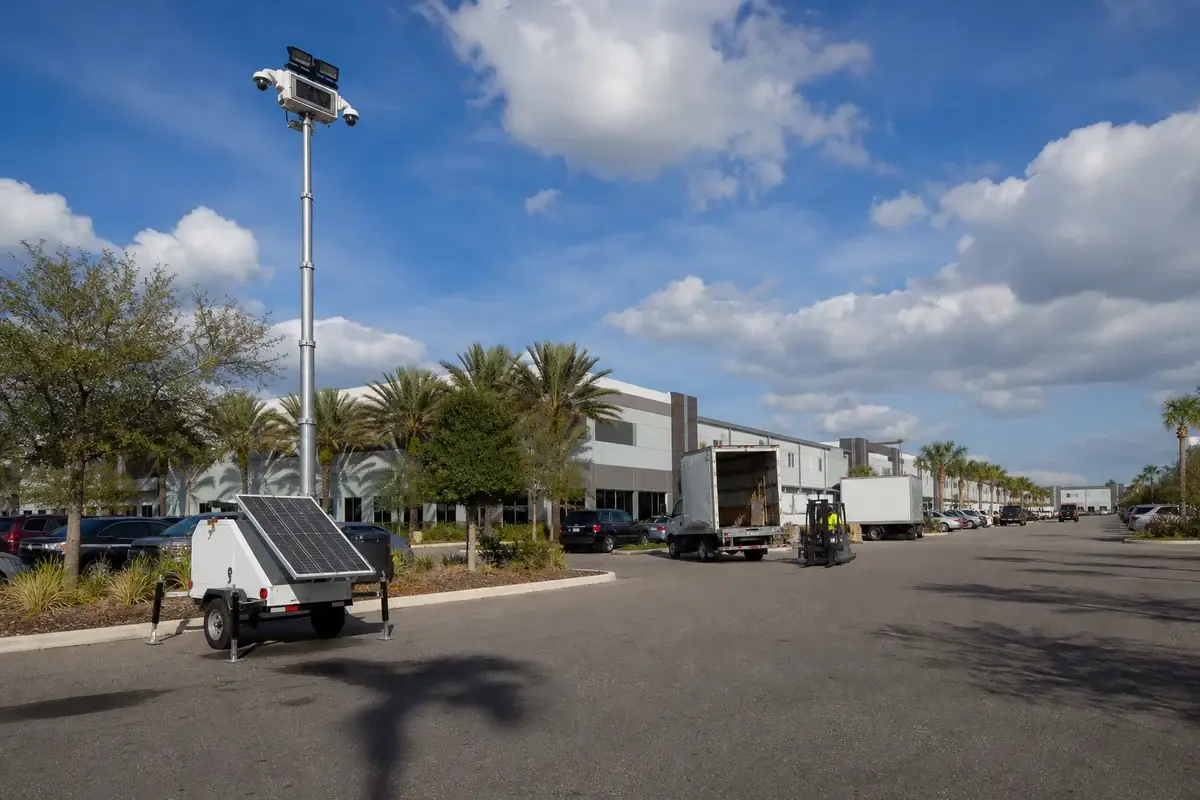Mobile solar security tower monitoring a commercial parking and logistics property in Orlando, Florida