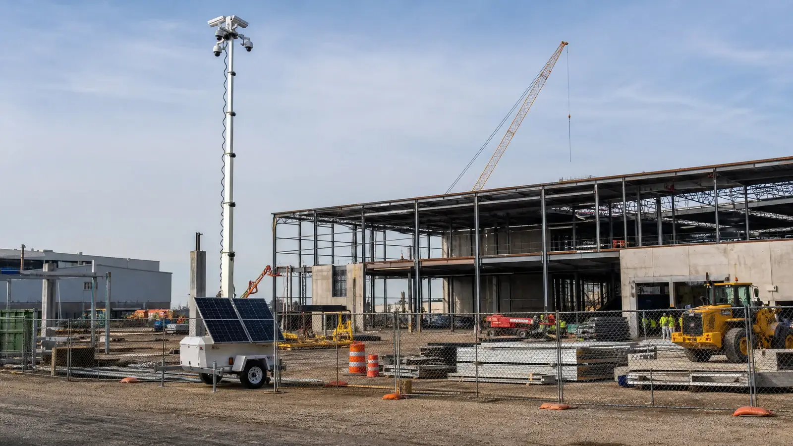 Commercial construction site protected by integrated security and mobile surveillance systems