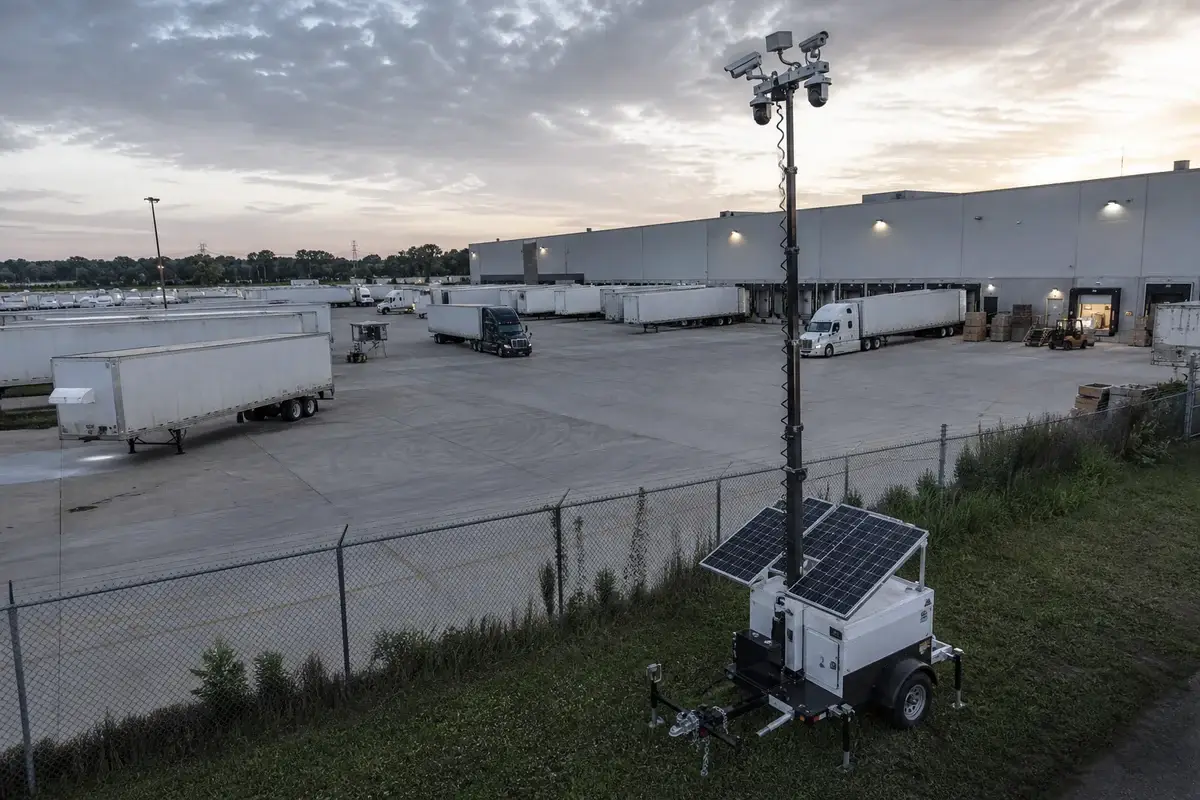Mobile surveillance tower monitoring a commercial logistics and trailer yard